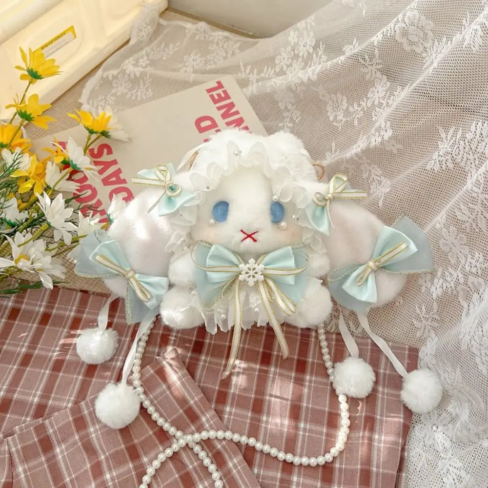 Lace Bow Bunny Plush Crossbody Bag: Blue bow bunny plush purse styled on plaid fabric beside flowers