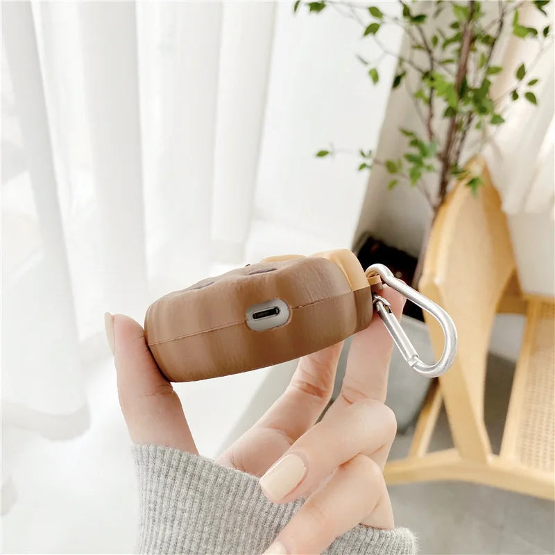 Teddy Bear Cookie AirPods Case: Bottom charging opening and side clip on brown cookie airpods cover