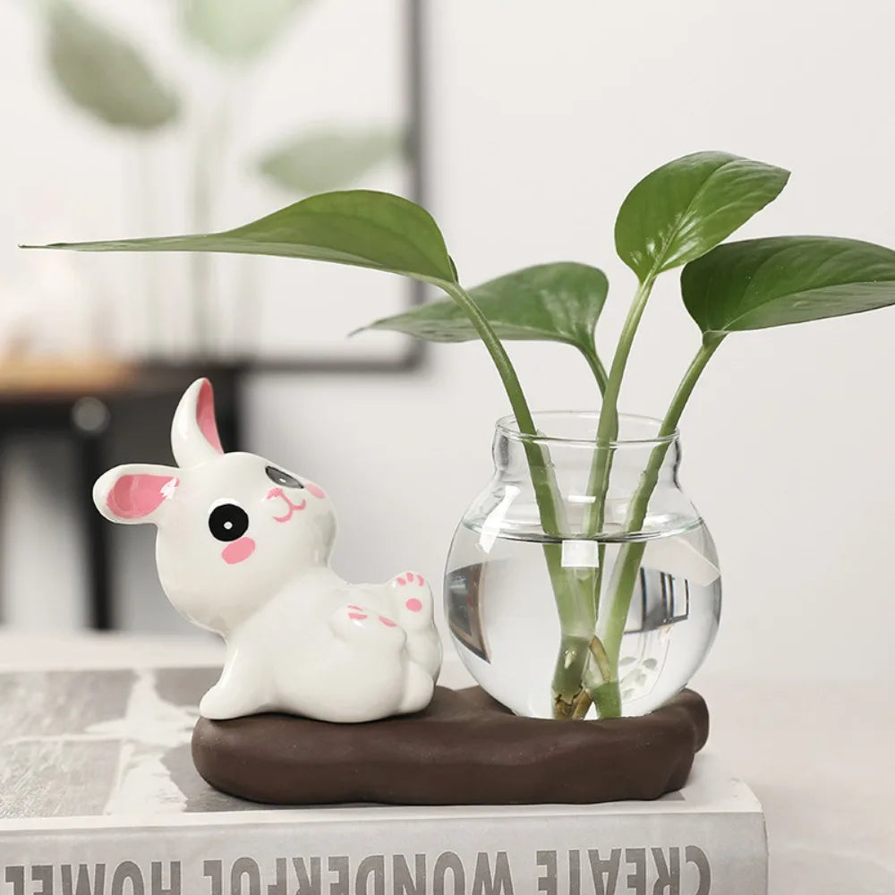 Bunny Glass Bud Vase: 07 sidelying white bunny with pink paws beside a leafy bud