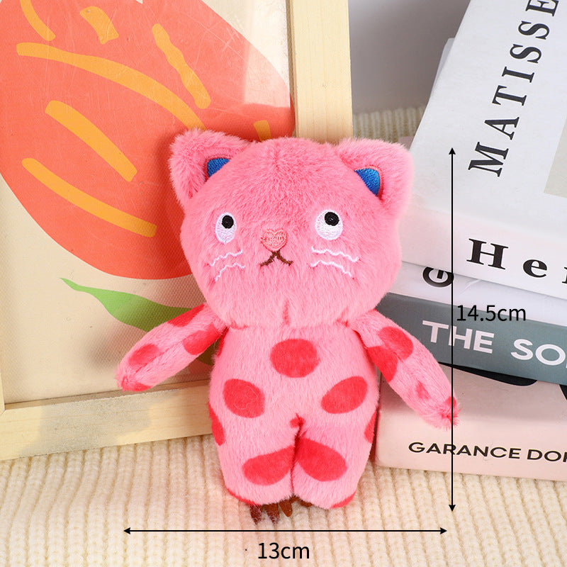 Pink cat plush bag charm with polka dot details