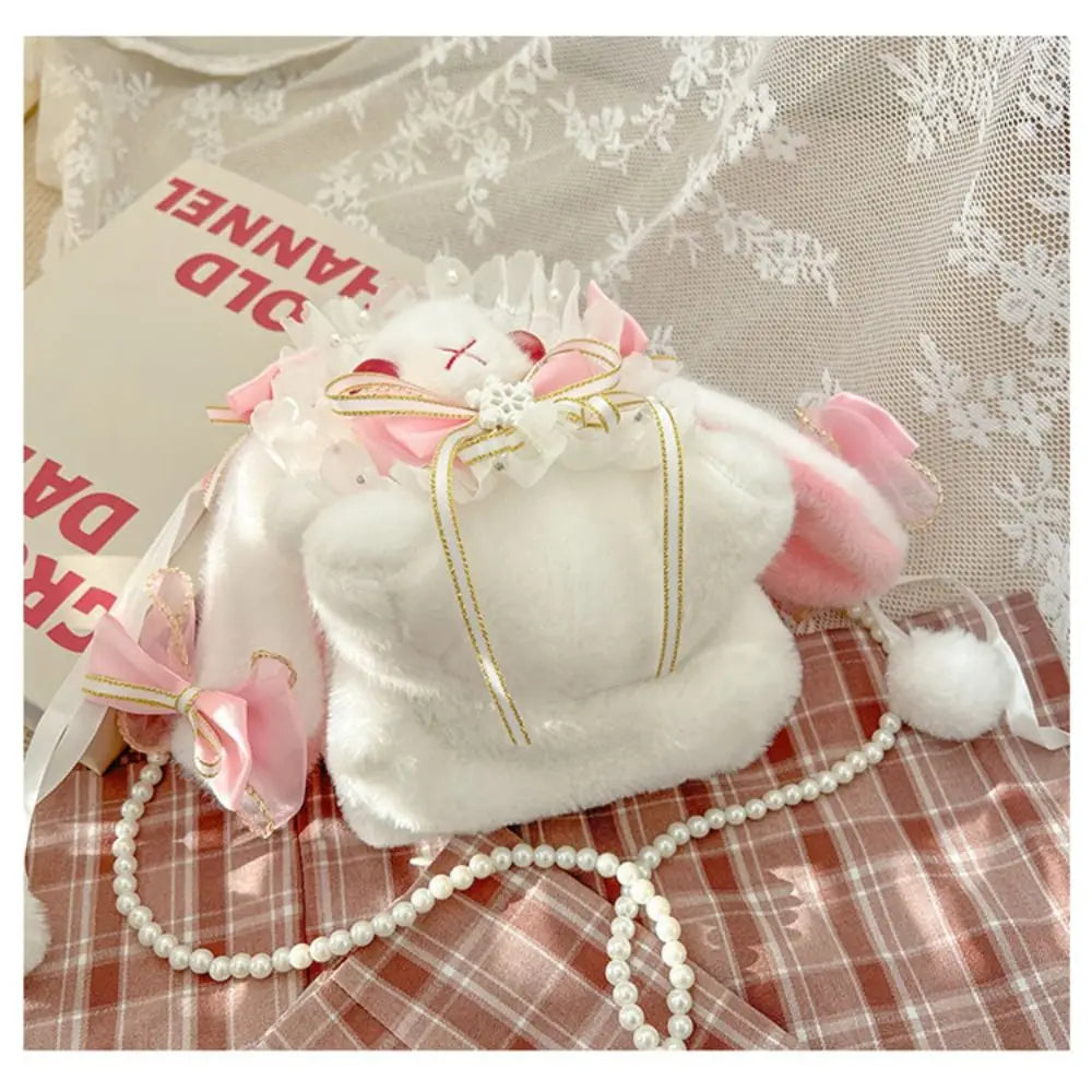 Lace Bow Bunny Plush Crossbody Bag: Pink bunny purse on lace and plaid fabric showing its bows and pom poms