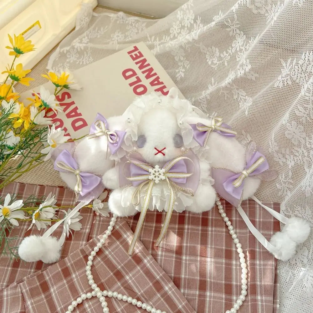 Lace Bow Bunny Plush Crossbody Bag: Purple bow bunny purse arranged on lace and plaid fabric