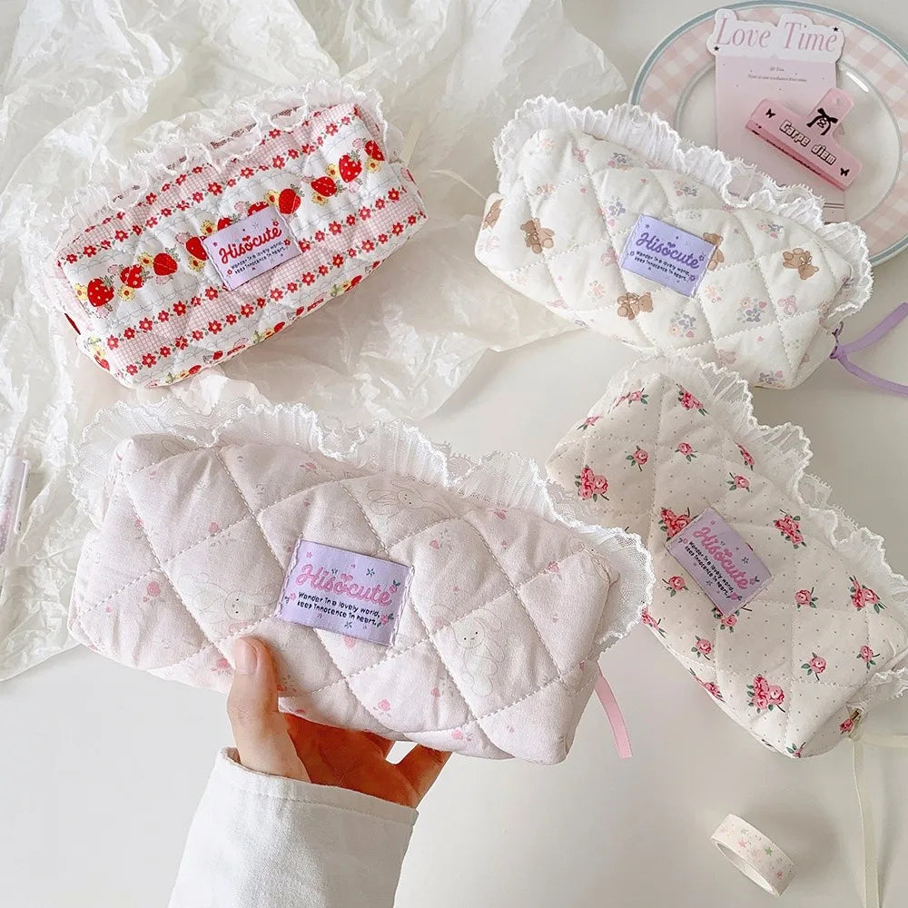 Quilted Ruffle Pencil Case: A pale pink rabbit pencil case is held above a desk alongside 3