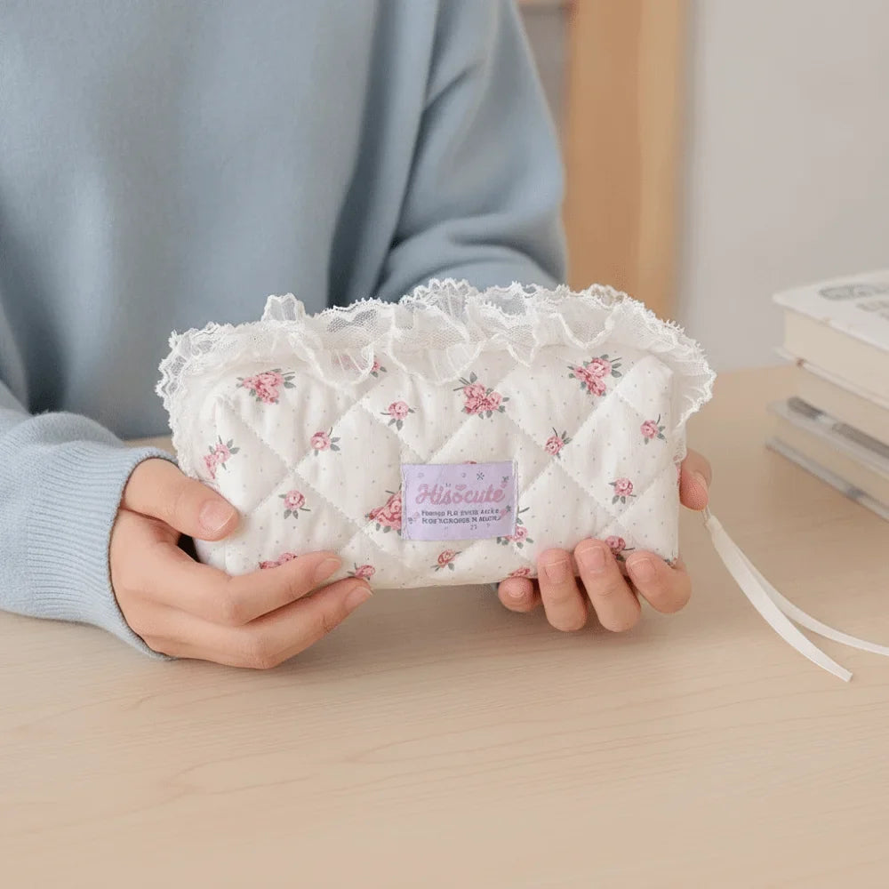 Quilted Ruffle Pencil Case: A person in a blue sweater holds a white quilted pencil case 2
