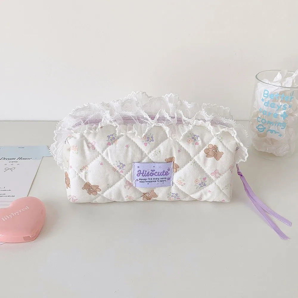 Quilted Ruffle Pencil Case: A white quilted pencil case with tiny bear motifs sits beside a 17