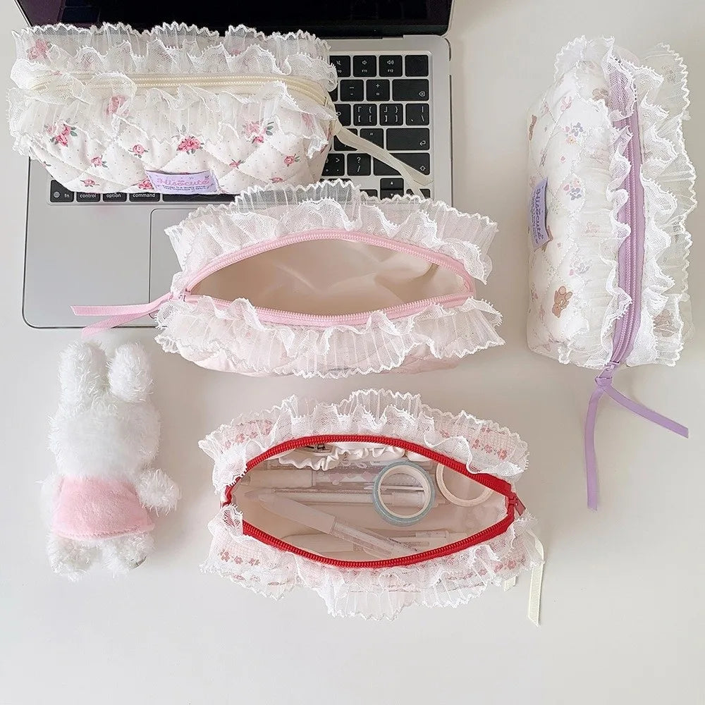 Quilted Ruffle Pencil Case: Several ruffled pencil cases are arranged beside a laptop including open pouches 4