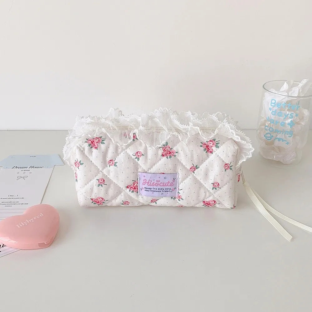 Quilted Ruffle Pencil Case: The floral quilted pencil case sits on a white desk beside a 12
