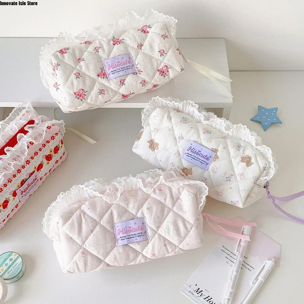 Quilted Ruffle Pencil Case: Three quilted ruffle pencil cases sit on a white desk with
