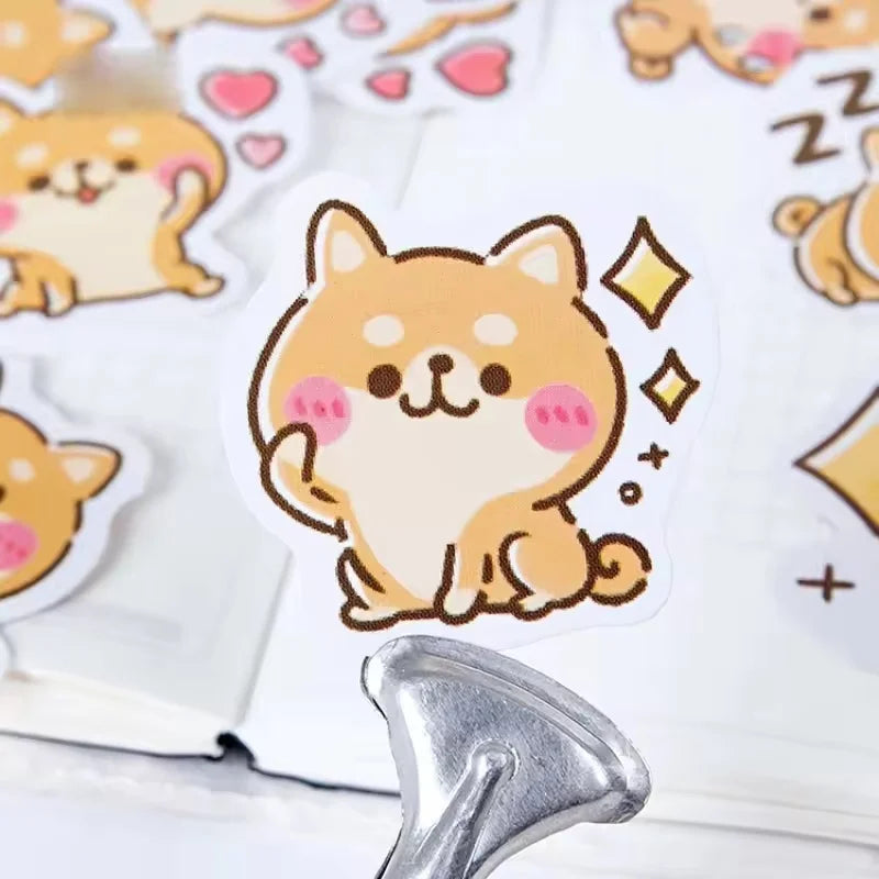 Rosy Puppy Sticker Box: Close up of a golden puppy sticker with pink cheeks and sparkle motifs