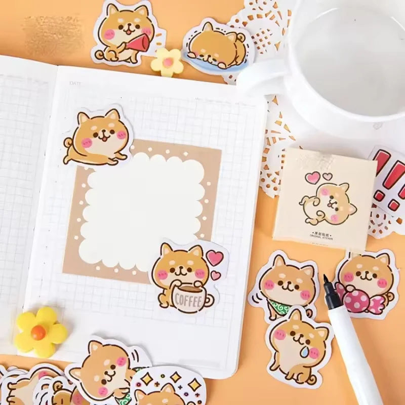Rosy Puppy Sticker Box: Puppy stickers used around a notebook page beside a cup and sticker box