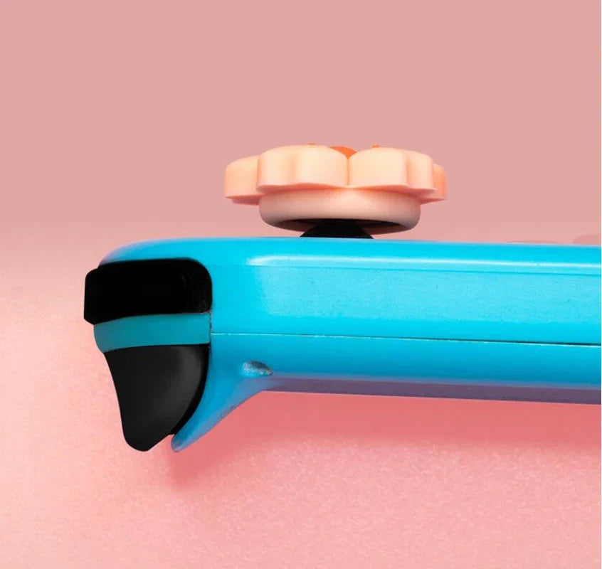 Sakura Flower Switch Thumb Grip Caps: Side profile of a pink sakura thumb grip on a blue controller