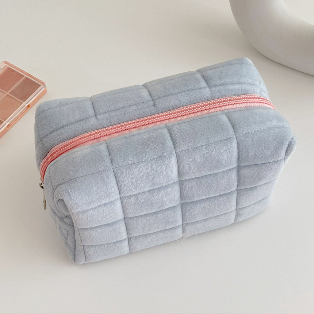 Blue quilted makeup bag with zip