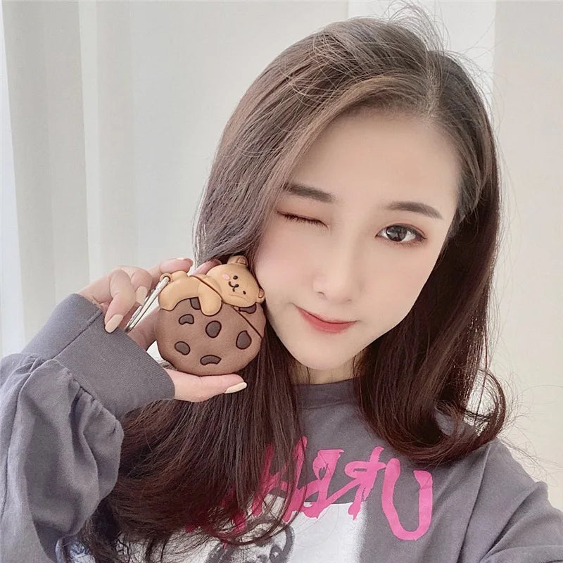 Teddy Bear Cookie AirPods Case: Teddy bear chocolate chip cookie case held beside a persons cheek